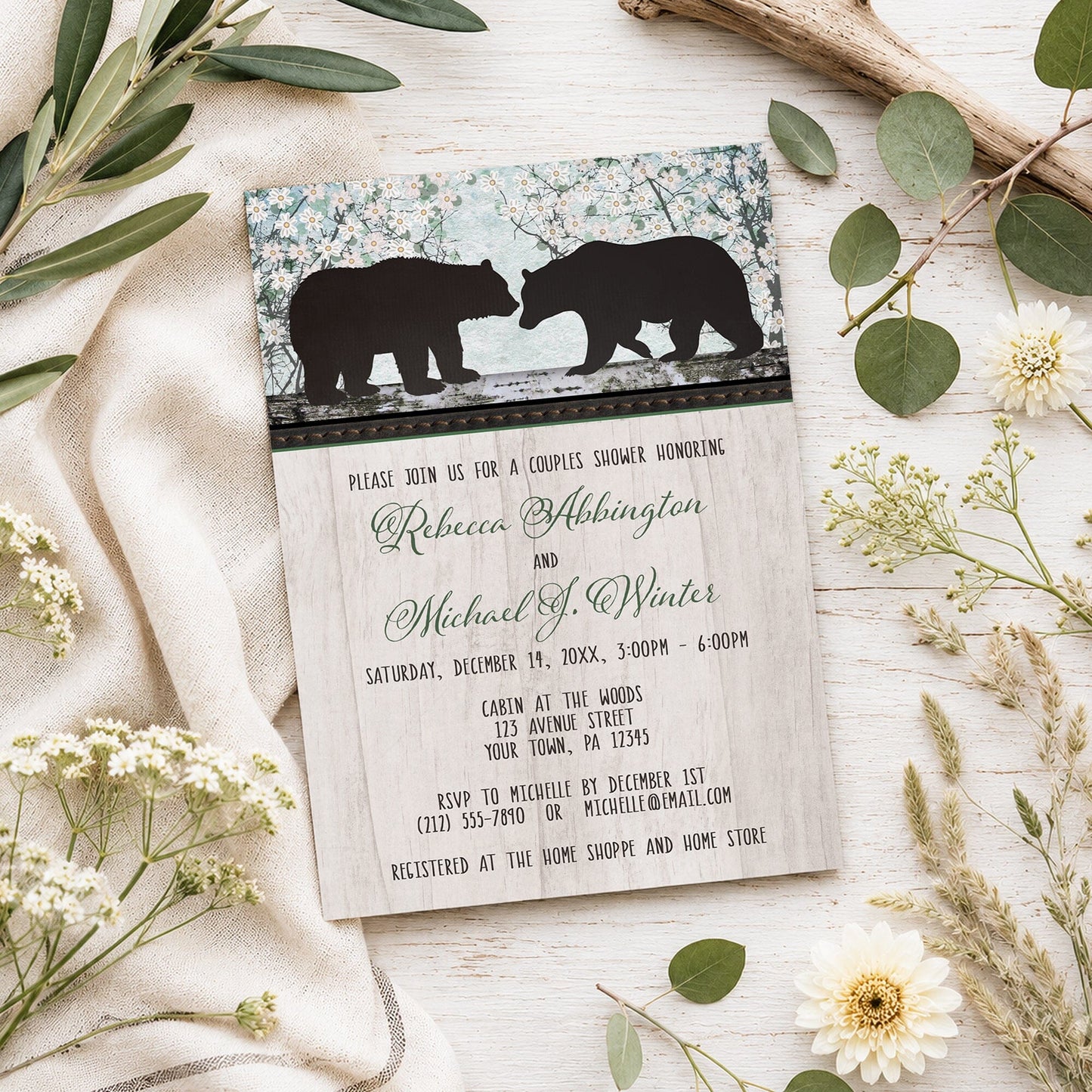 Rustic Bear Floral Wood Couples Shower Invitation shown on a light wooden surface with spring and summer plants.