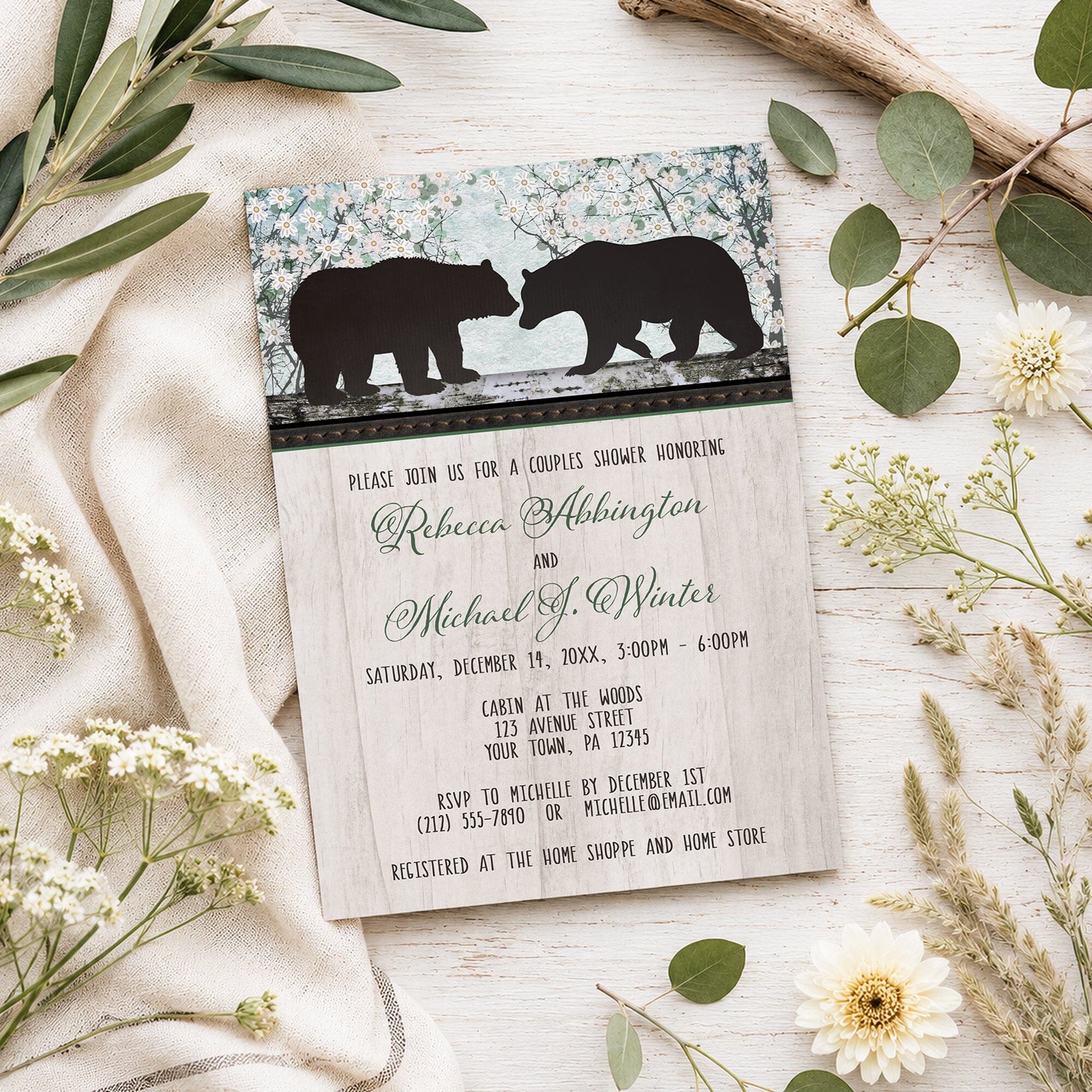 Rustic Bear Floral Wood Couples Shower Invitation shown on a light wooden surface with spring and summer plants.