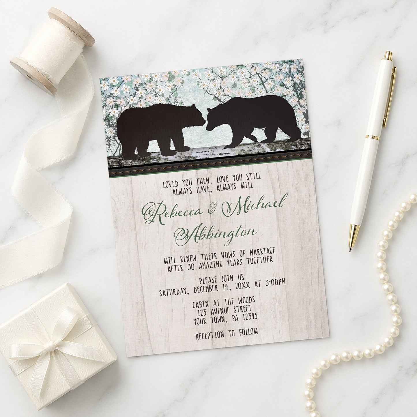Rustic Bear Floral Wood Vow Renewal Invitation shown on a marble surface with a white gift box, ribbon, pen, and pearls.
