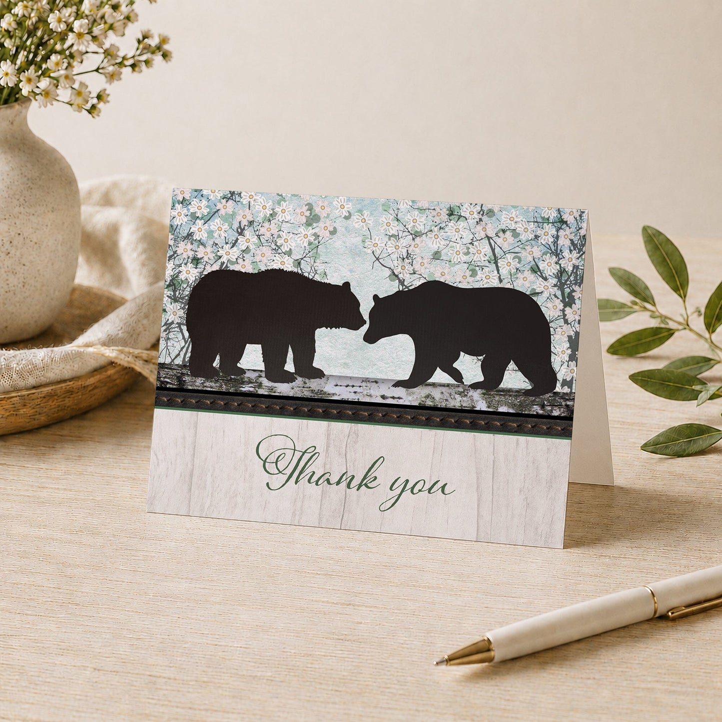 Rustic Bear Spring Floral Wood Thank You Card shown on a desk with a vase, plants, and a pen.