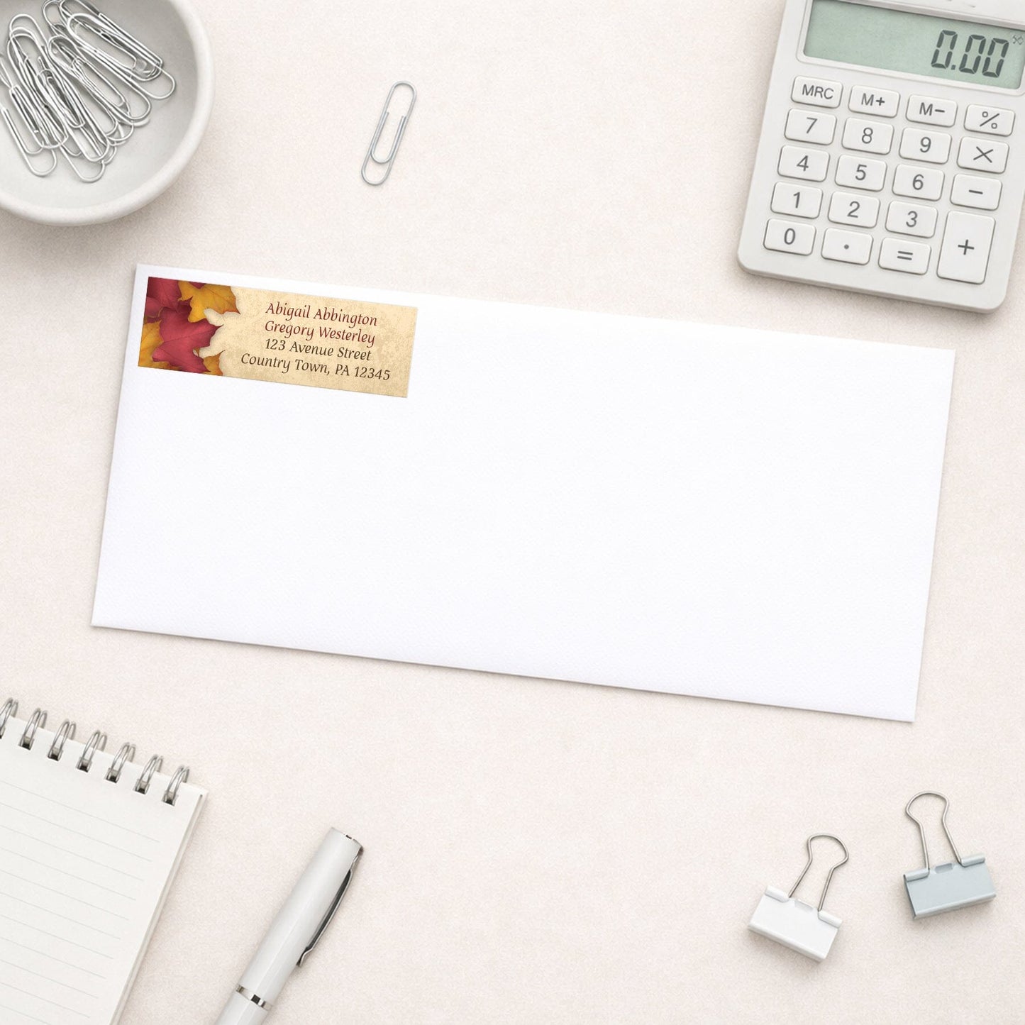 Rustic Burgundy Gold Autumn Address Label shown on a white envelope with everyday office supplies
