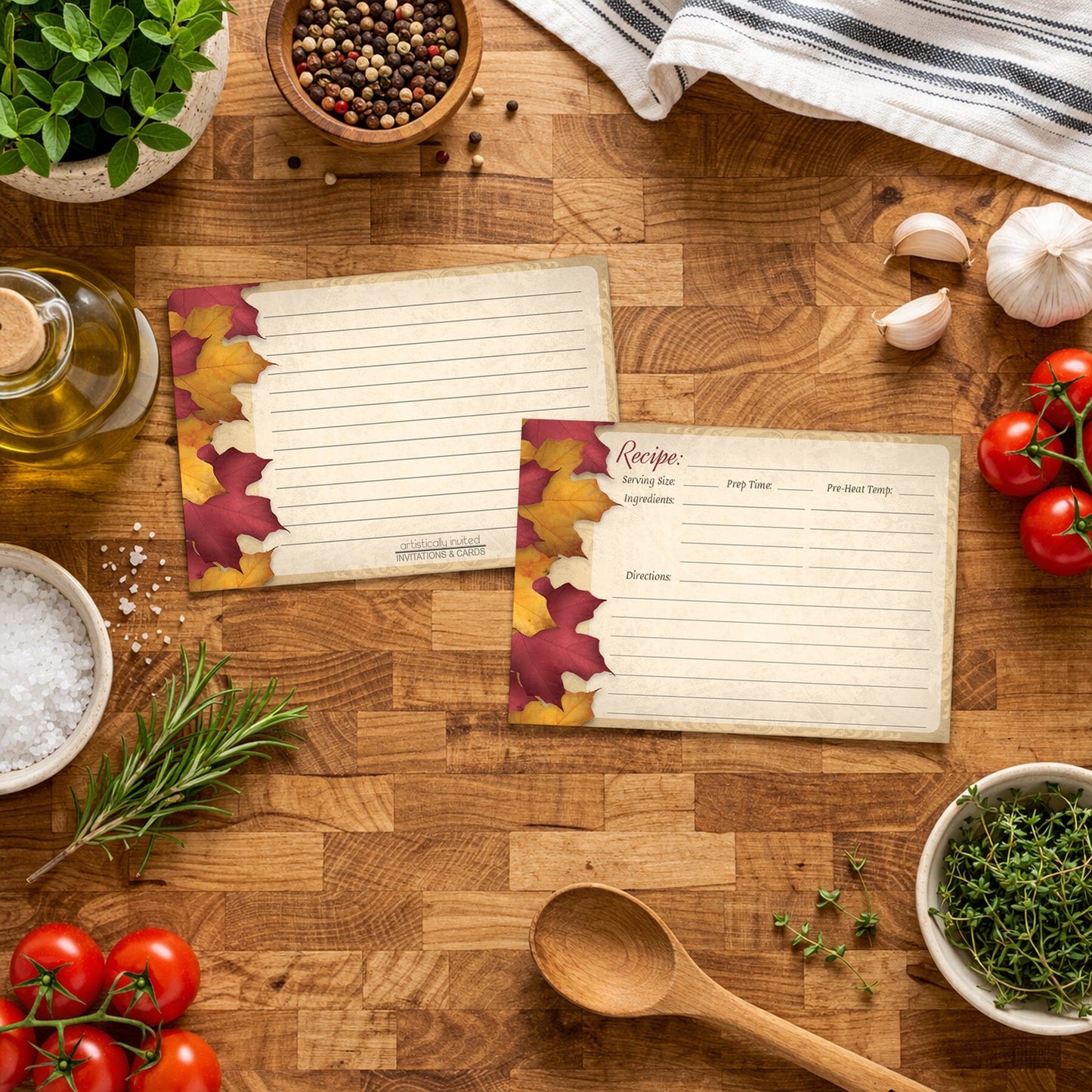 Two Rustic Burgundy Gold Autumn Recipe Cards on a wooden butcher block surface with Italian cooking ingredients and utensils.
