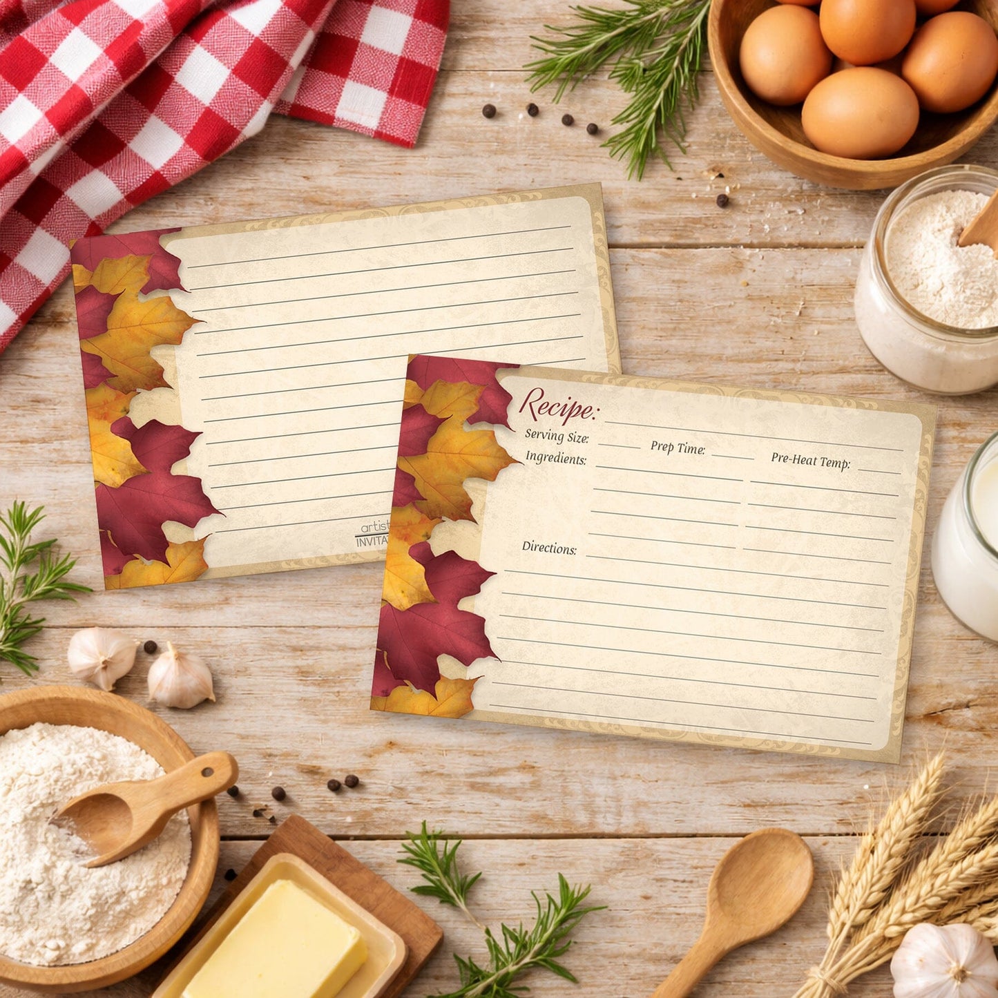 Two Rustic Burgundy Gold Autumn Recipe Cards on a wooden surface in a country kitchen with cooking ingredients.