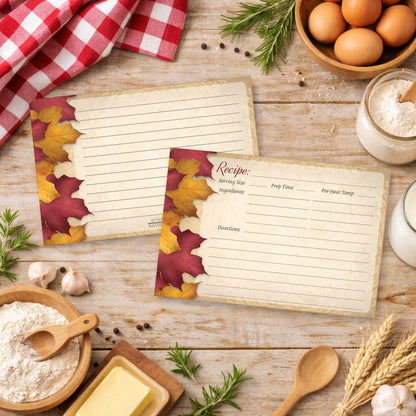 Two Rustic Burgundy Gold Autumn Recipe Cards on a wooden surface in a country kitchen with cooking ingredients.