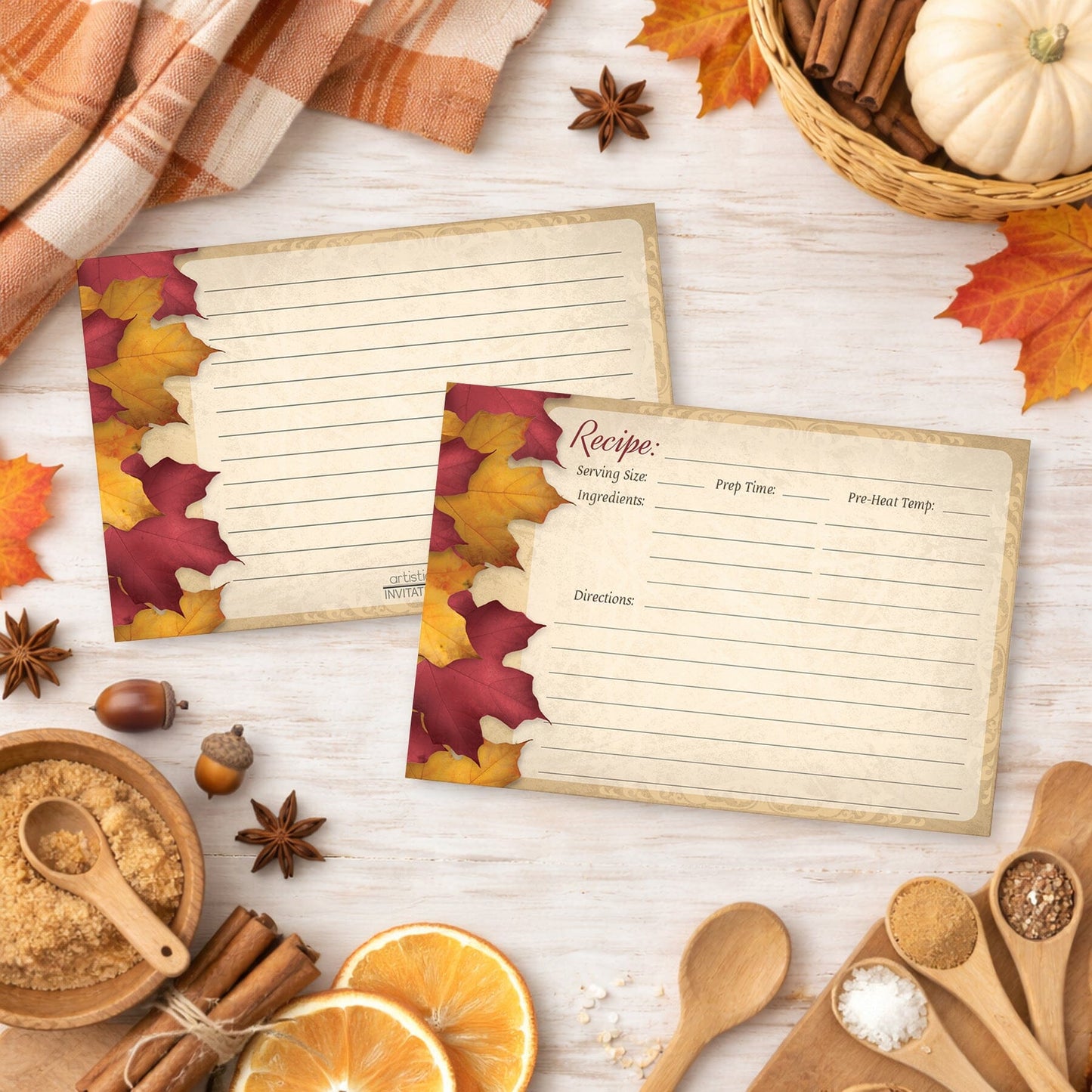 Two Rustic Burgundy Gold Autumn Recipe Cards on a wooden surface with fall decorations.