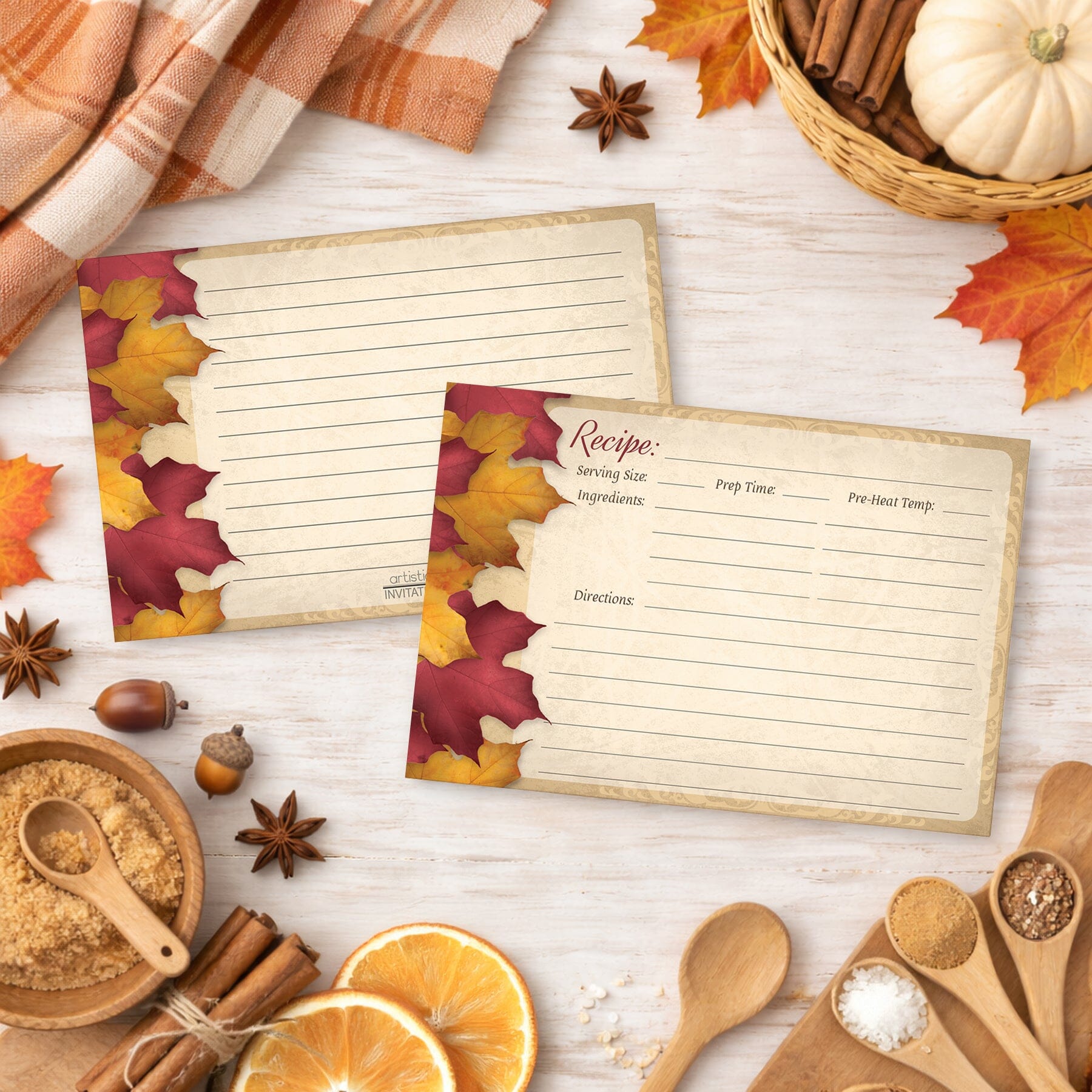 Two Rustic Burgundy Gold Autumn Recipe Cards on a wooden surface with fall decorations.