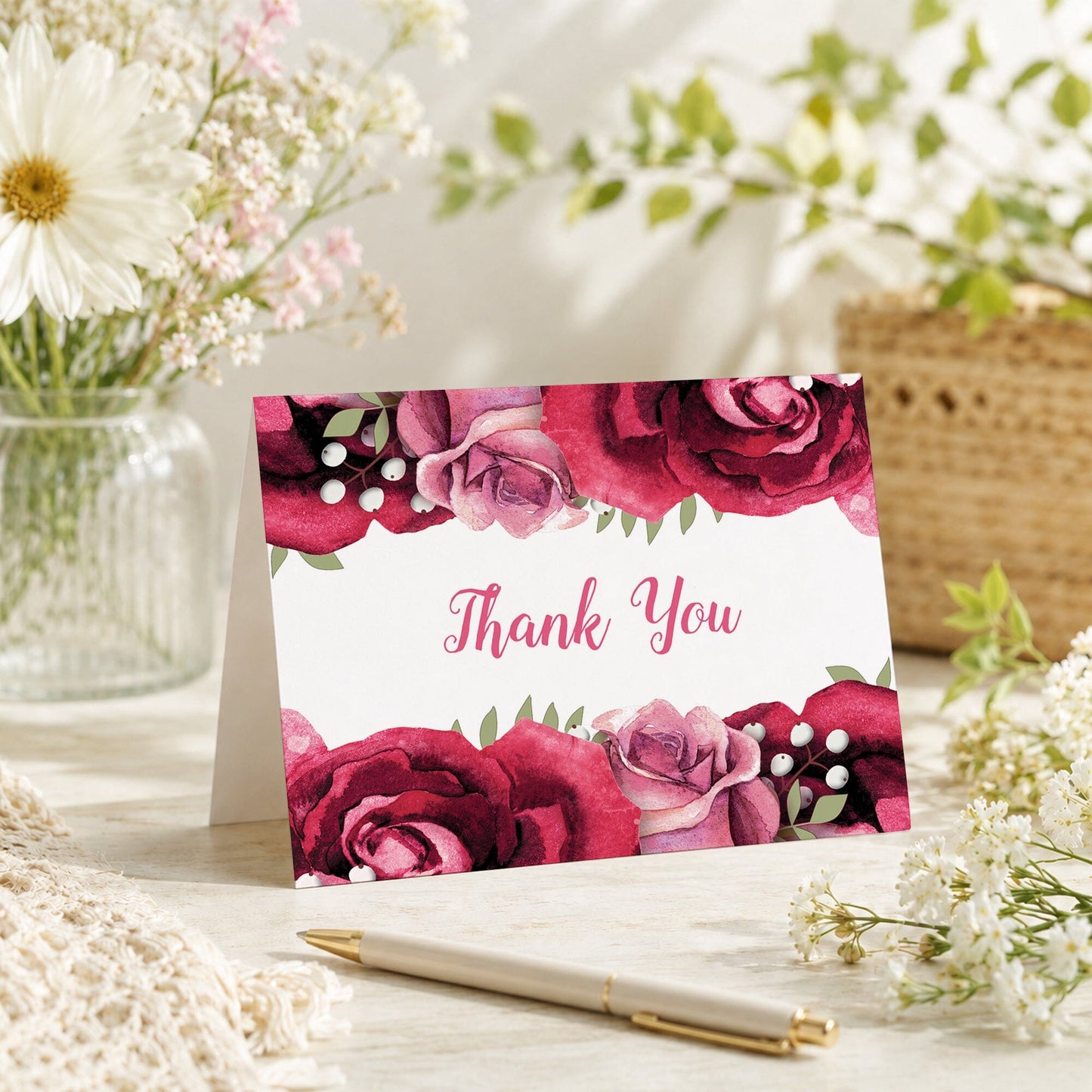 Rustic Burgundy Pink Rose Thank You Card shown on a tabletop with a vase, spring and summer flowers, and a pen.
