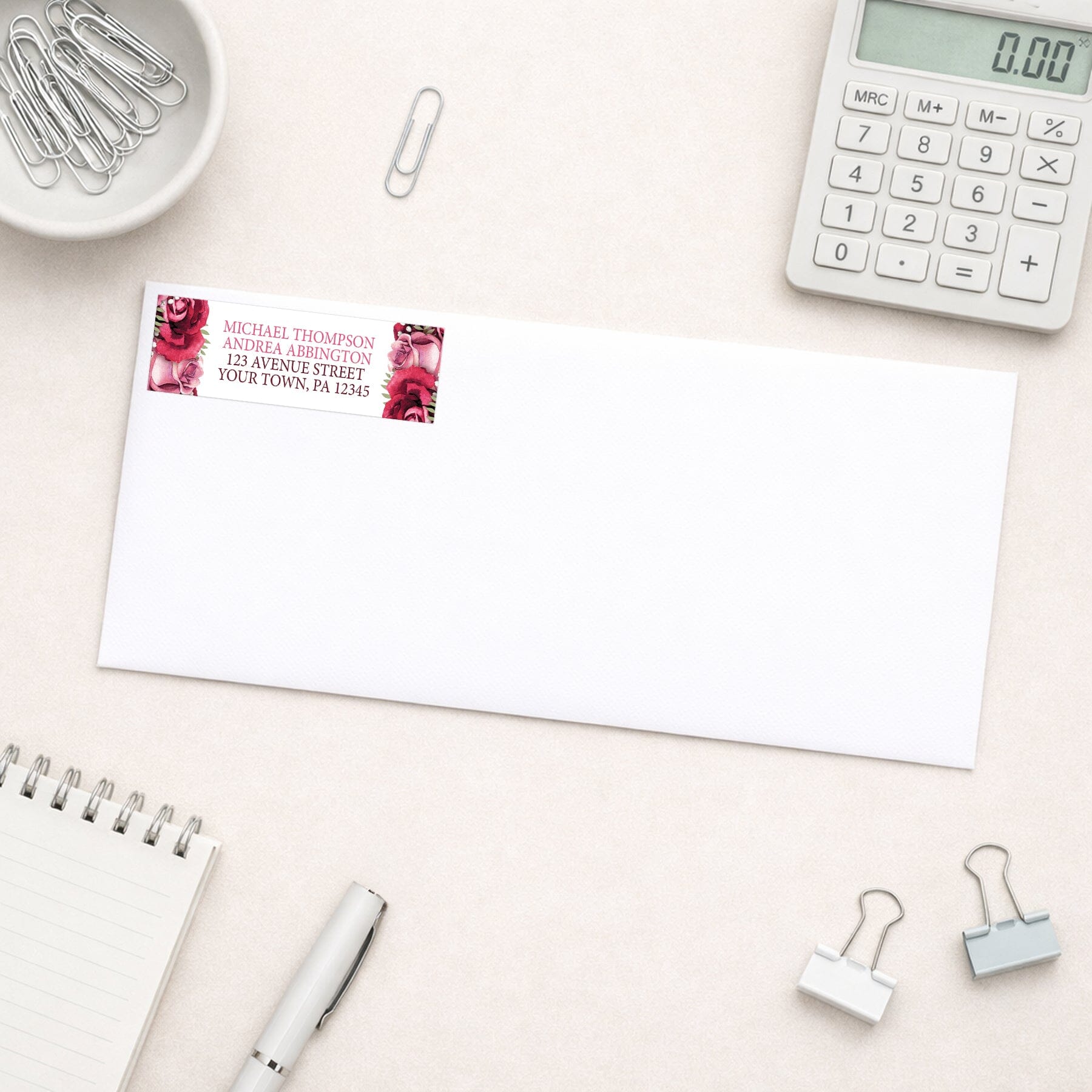 Rustic Burgundy Pink Rose White Address Label shown on a white envelope with everyday office supplies