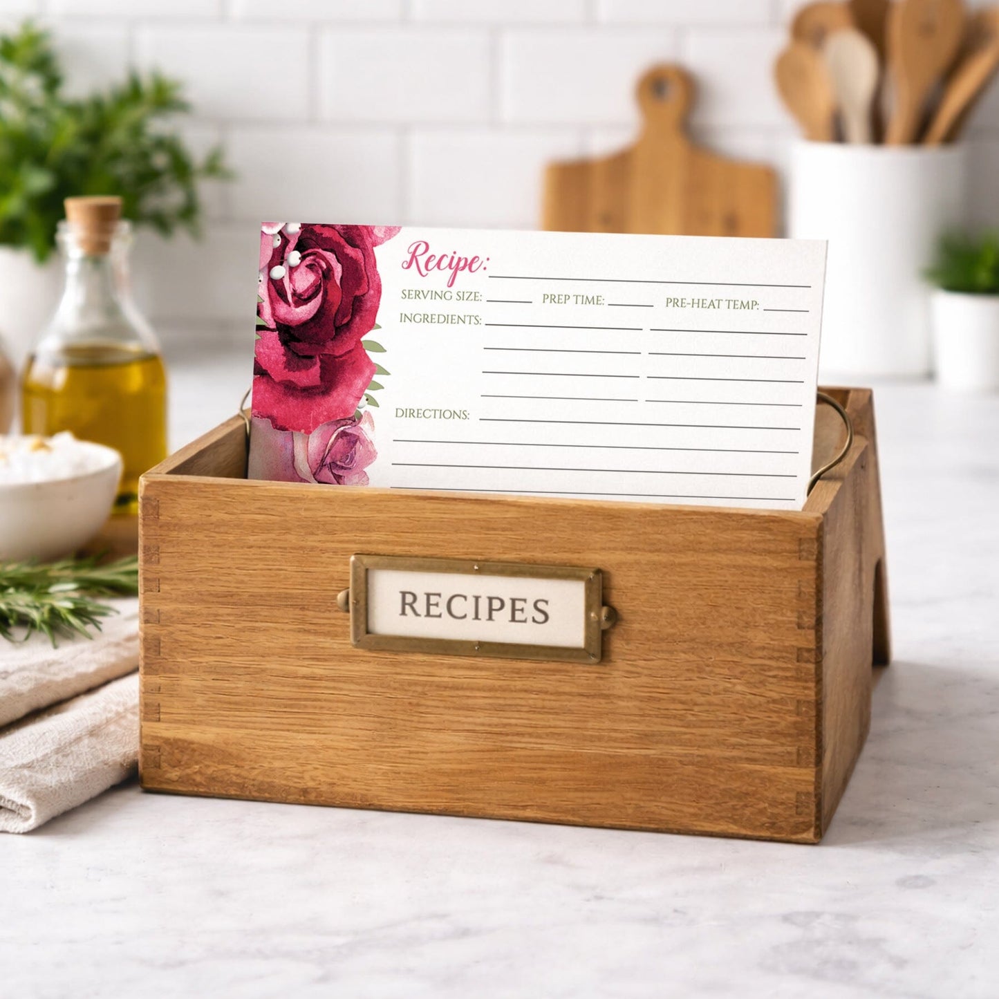 Wooden recipe box with a Rustic Burgundy Pink Rose White Recipe Card on a kitchen counter.