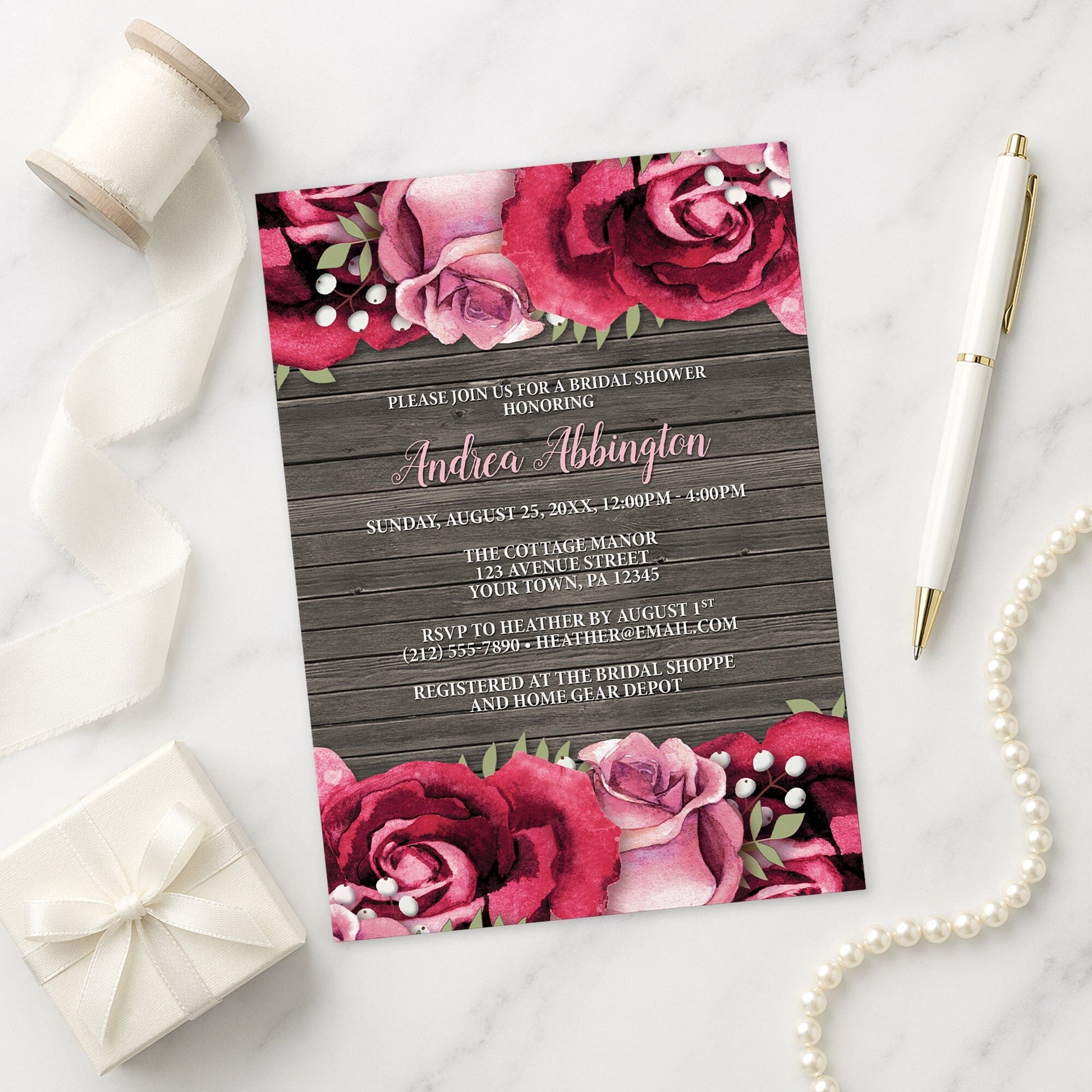 Rustic Burgundy Pink Rose Wood Bridal Shower Invitation shown on a marble surface with a white gift box, pen, ribbon, and pearls.