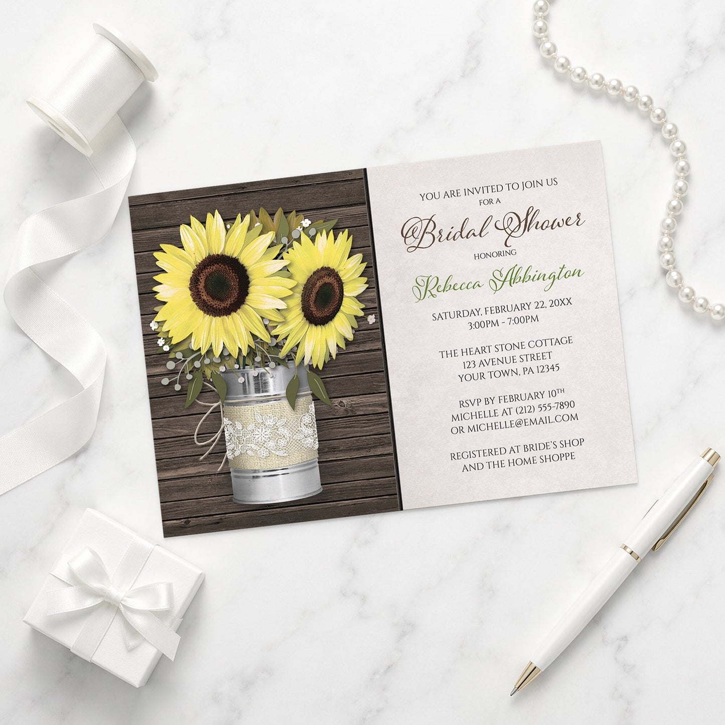 Rustic Burlap and Lace Tin Can Sunflower Bridal Shower Invitation on a marble surface with a white gift box, pen, and pearls.