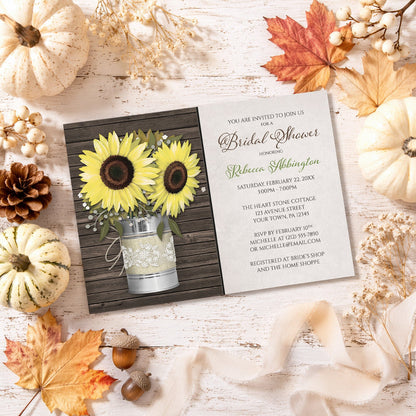 Rustic Burlap and Lace Tin Can Sunflower Bridal Shower Invitation on a wooden surface with fall leaves and autumn decorations.