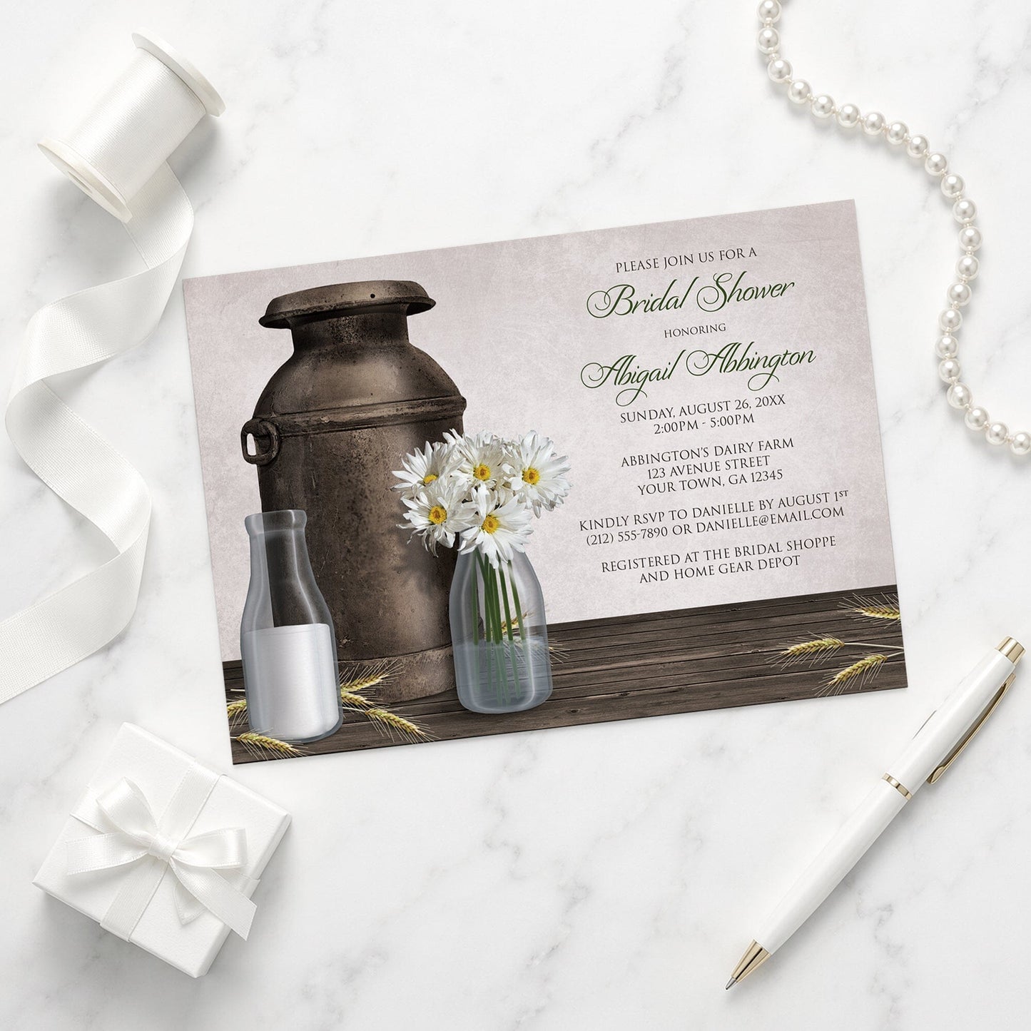 Rustic Country Dairy Farm Bridal Shower Invitation shown on a marble surface with a white gift box, pen, ribbon, and pearls.