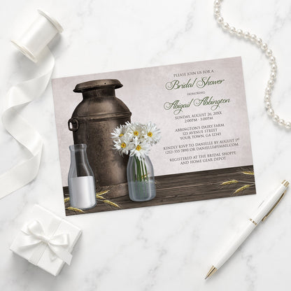 Rustic Country Dairy Farm Bridal Shower Invitation shown on a marble surface with a white gift box, pen, ribbon, and pearls.