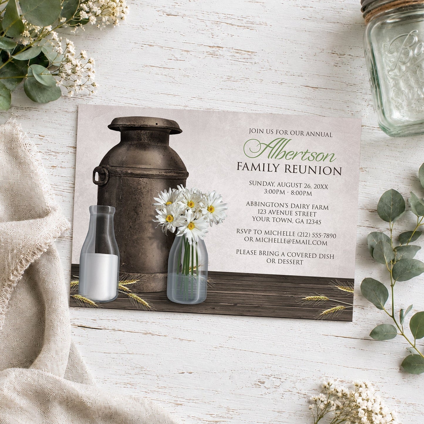Rustic Country Dairy Farm Family Reunion Invitation shown on a wooden surface with neutral plants and a mason jar.