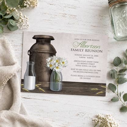 Rustic Country Dairy Farm Family Reunion Invitation shown on a wooden surface with neutral plants and a mason jar.
