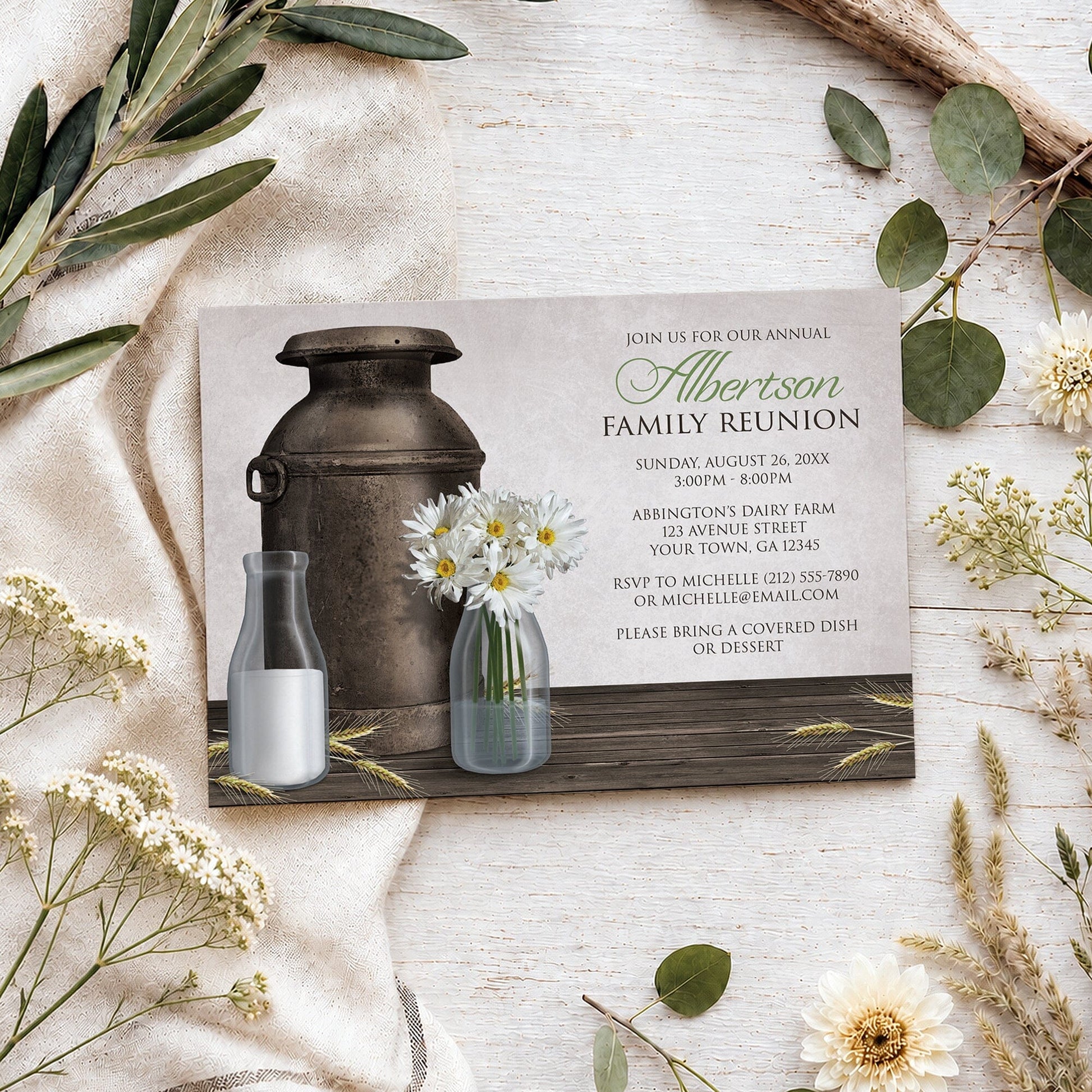 Rustic Country Dairy Farm Family Reunion Invitation shown on a light wooden surface with spring and summer flowers and branches.