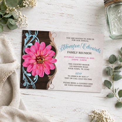 Rustic Country Pink Zinnia Family Reunion Invitation shown on a light wooden surface with plants and a small mason jar.