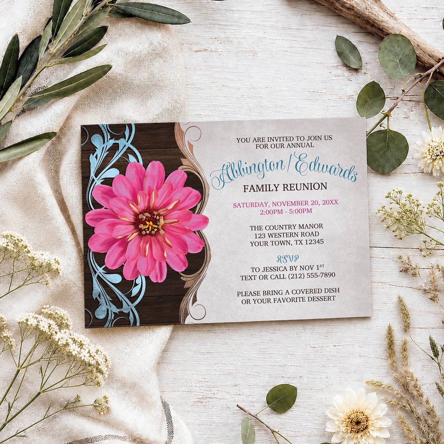 Rustic Country Pink Zinnia Family Reunion Invitation shown on a light wooden surface with spring and summer plants.