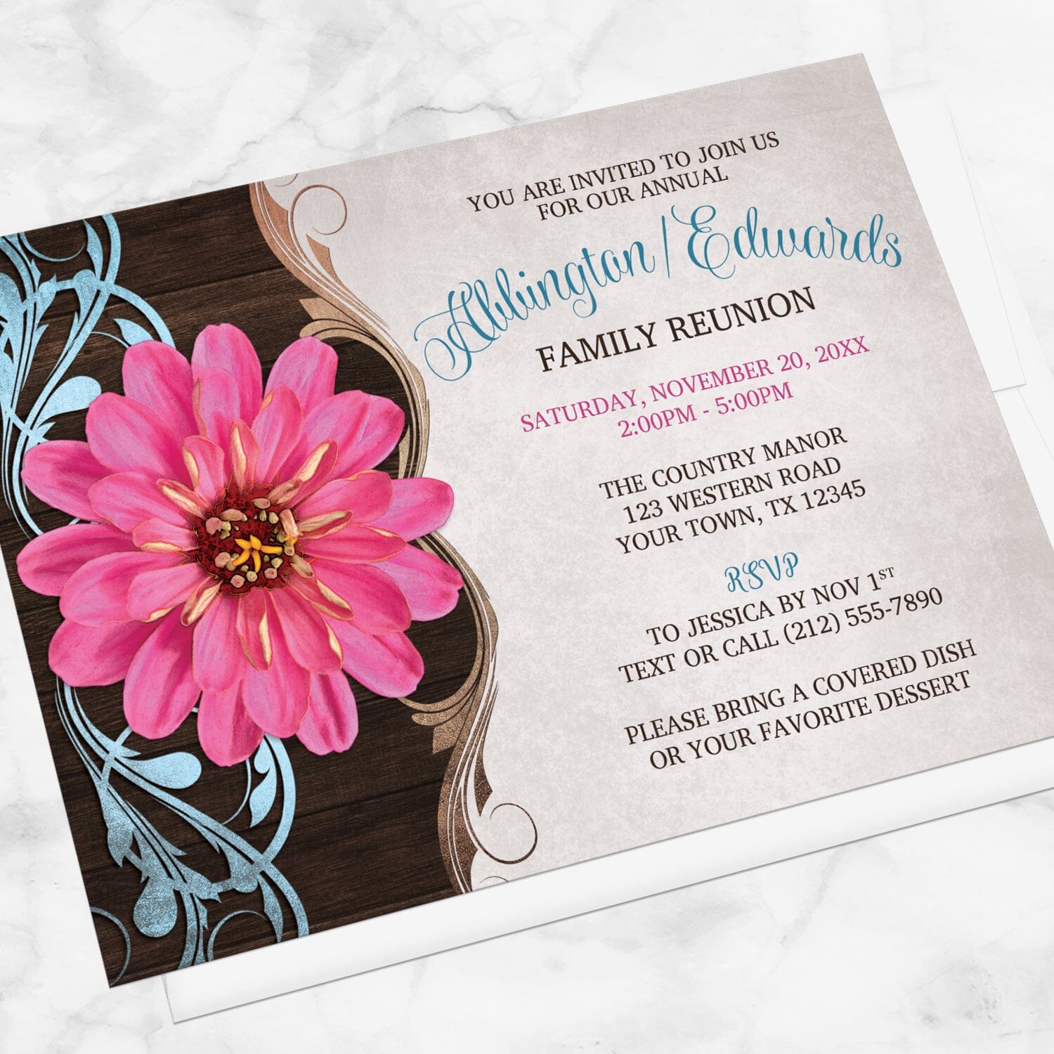 Rustic Country Pink Zinnia Family Reunion Invitation shown at an angle on a marble surface with a white envelope.