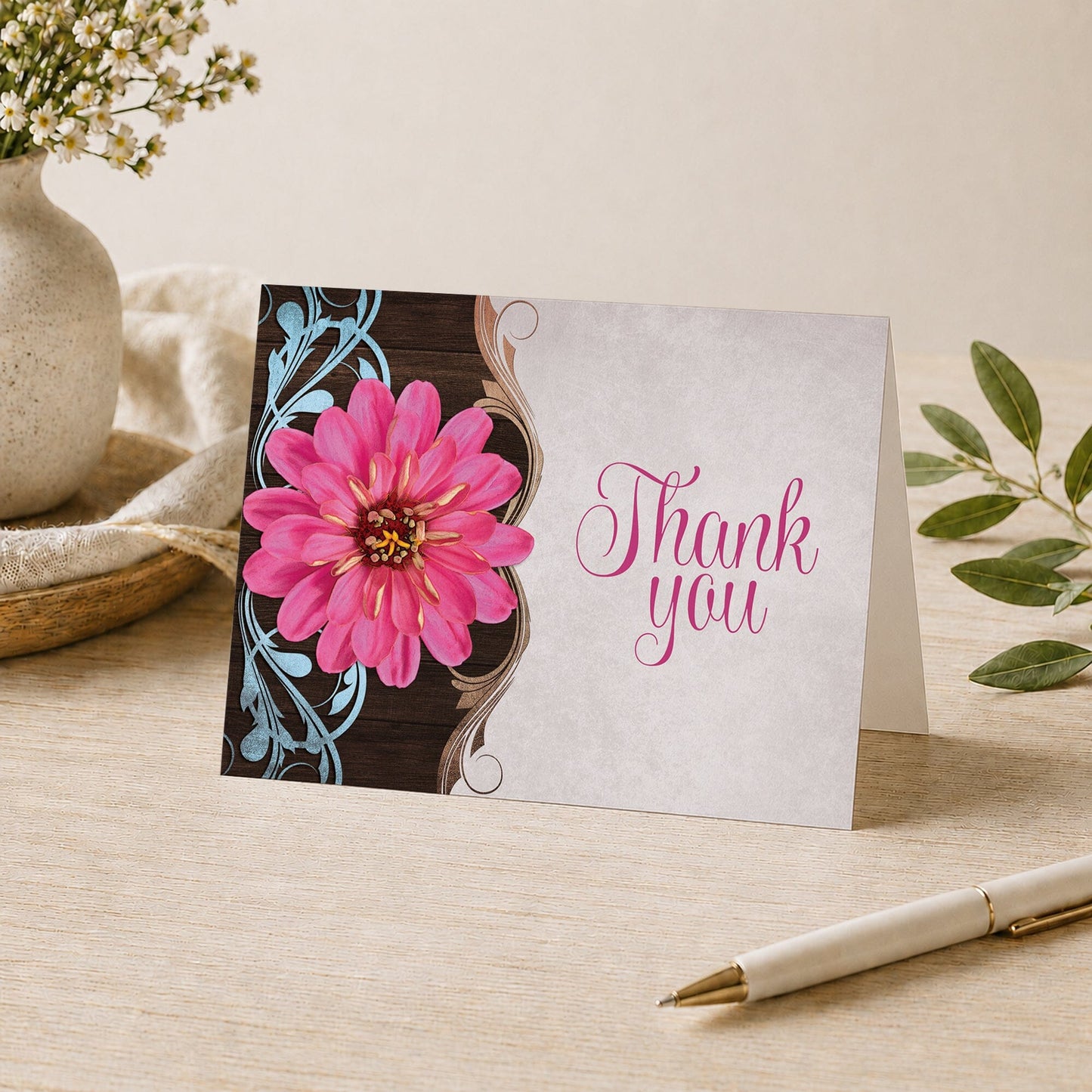 Rustic Country Pink Zinnia Thank You Card shown on a desk with a vase, plants, and a pen.