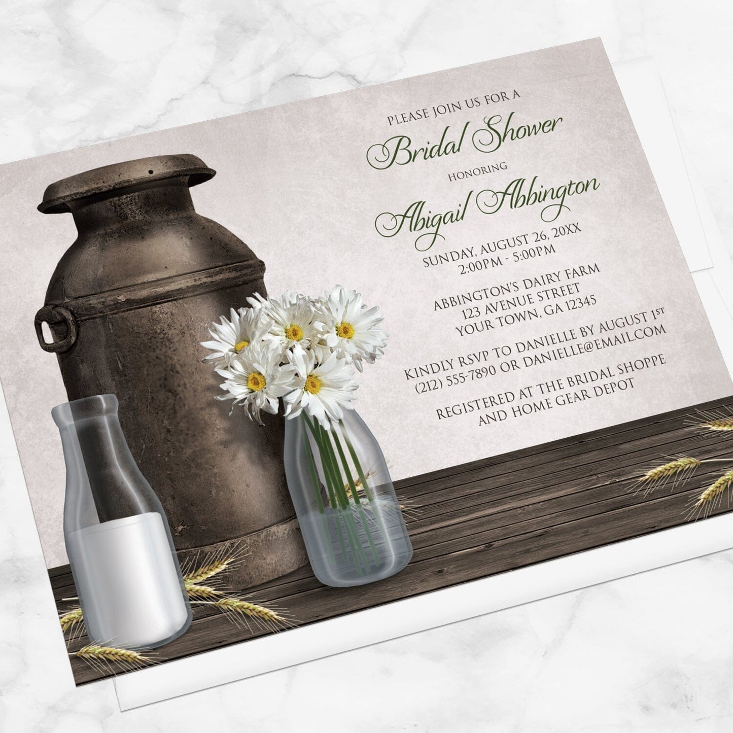 Rustic Country Dairy Farm Bridal Shower Invitation shown at an angle on a marble surface with a white envelope.