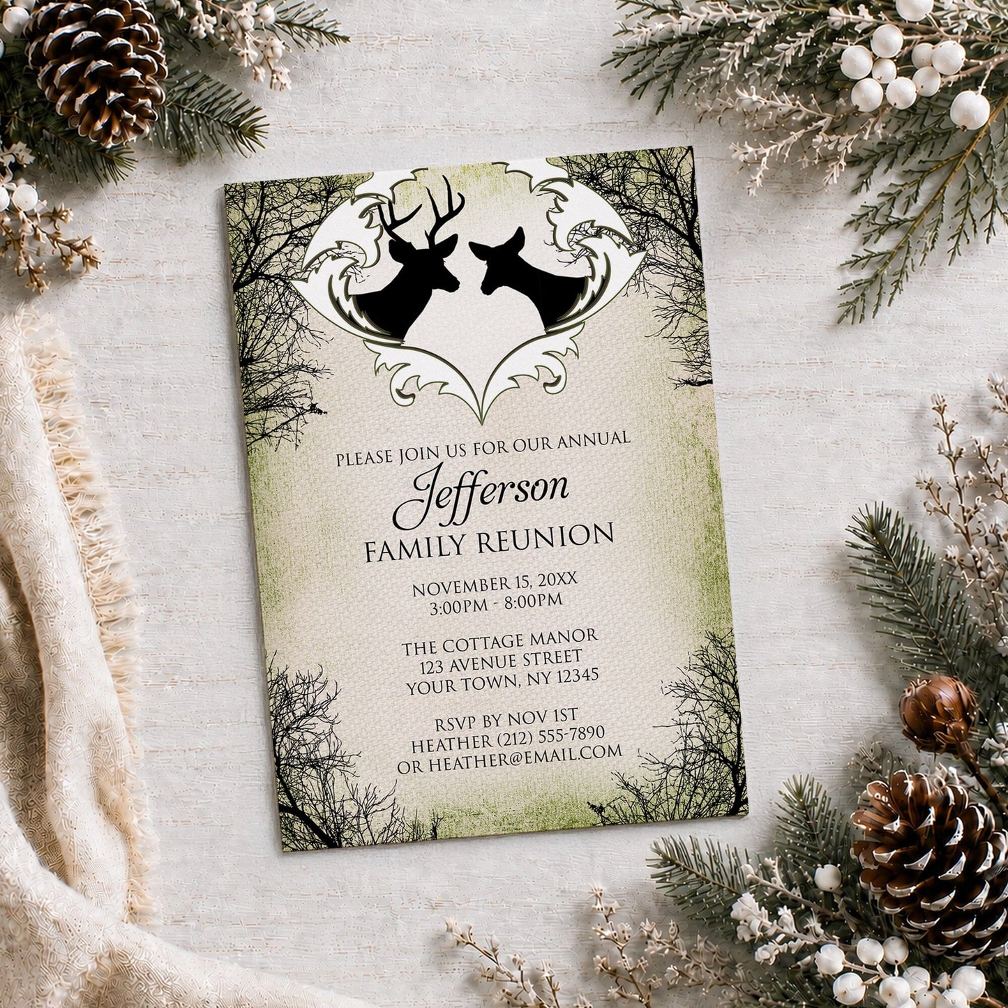 Rustic Deer Frame Canvas Family Reunion Invitation shown on a light wooden surface with winter greenery and pine cones.