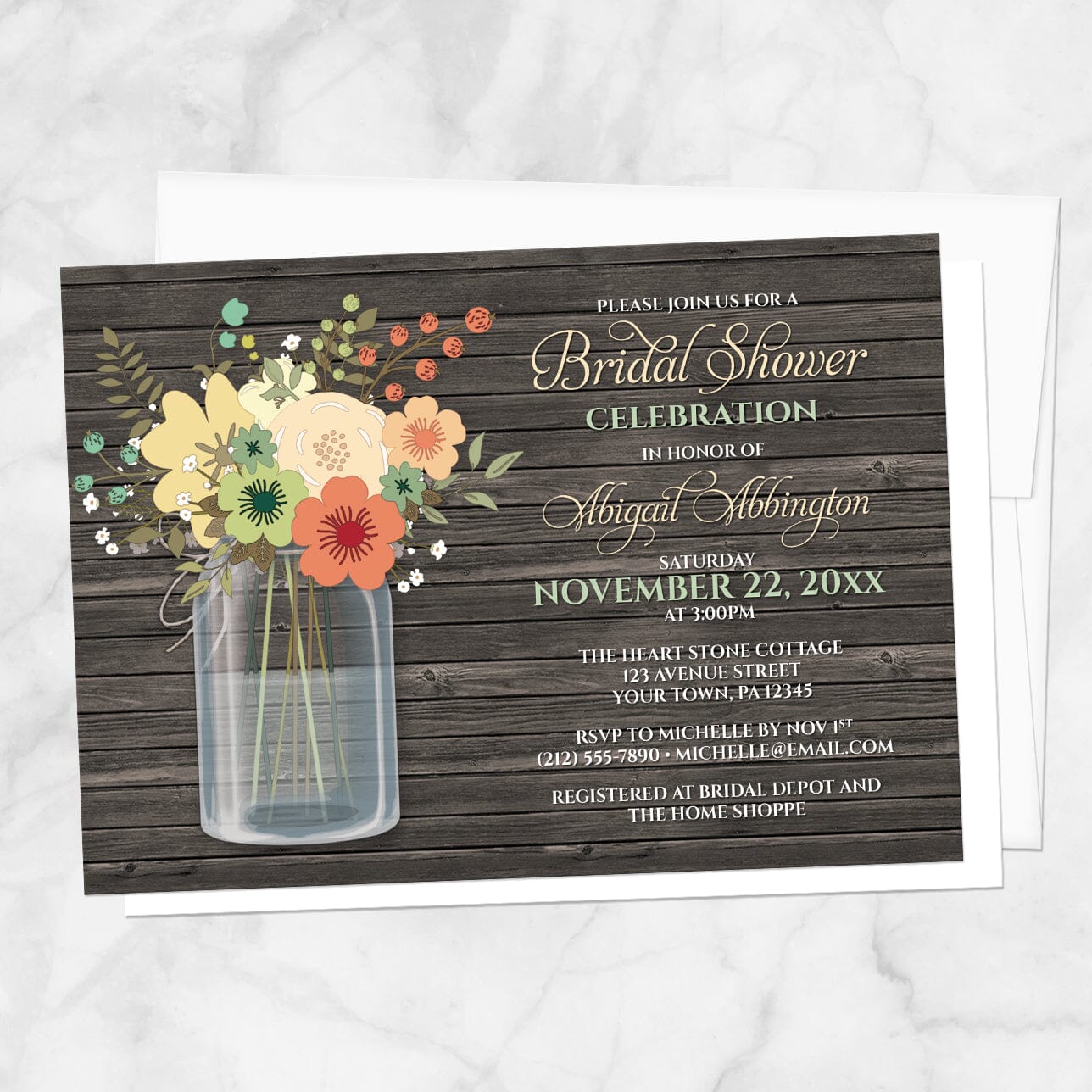 Bridal shower invitation with flowers in a mason jar on a wooden background, with a white envelope, on a marble surface