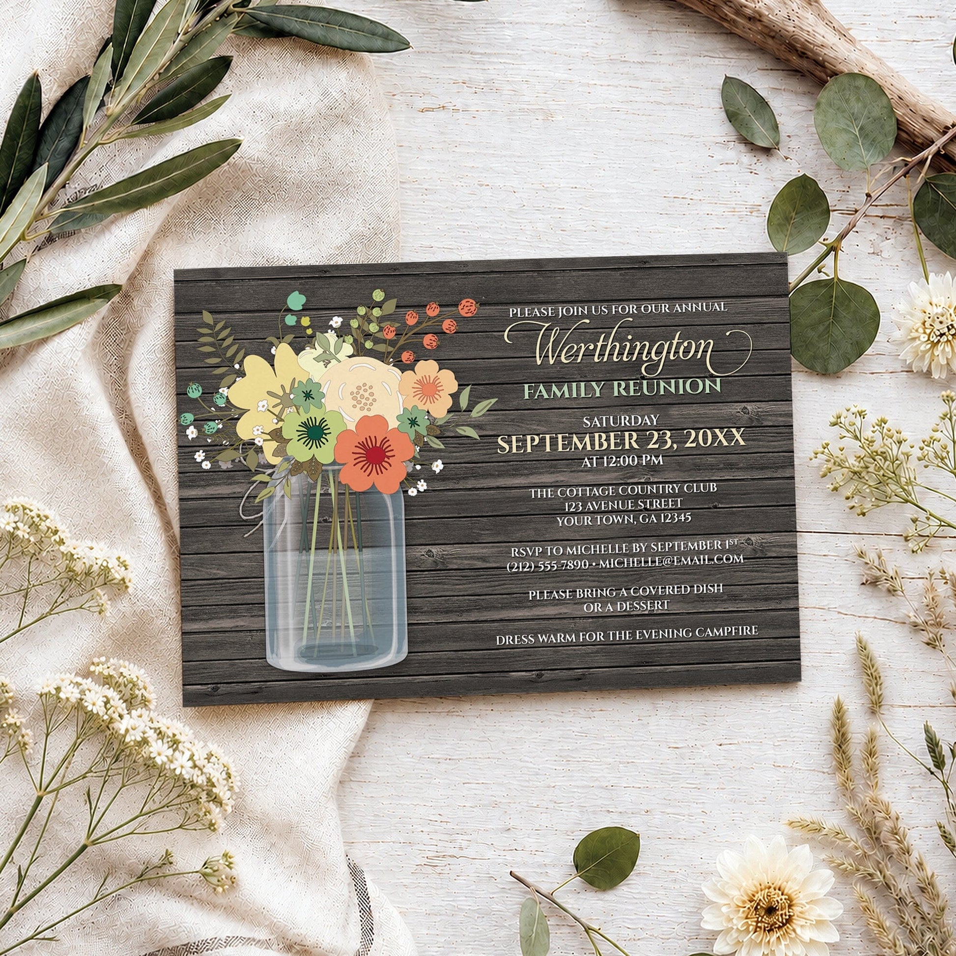 Rustic Floral Wood Mason Jar Family Reunion Invitation shown on a wooden surface with spring and summer plants.