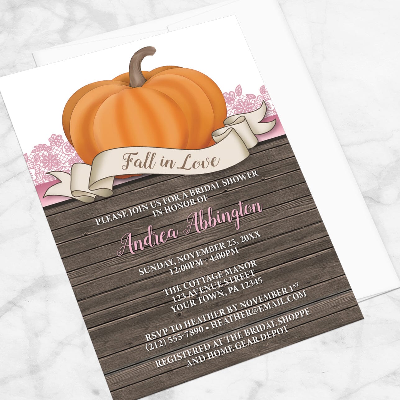 Bridal Shower invitation with a all in Love theme title, orange pumpkin, pink lace, and rustic wood, displayed at an angle with a white envelope on a marble surface