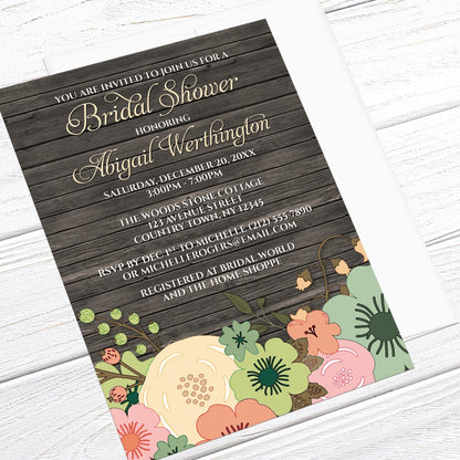 Rustic Orange Teal Floral Wood Bridal Shower Invitation shown at an angle on a light wood surface with a white envelope.