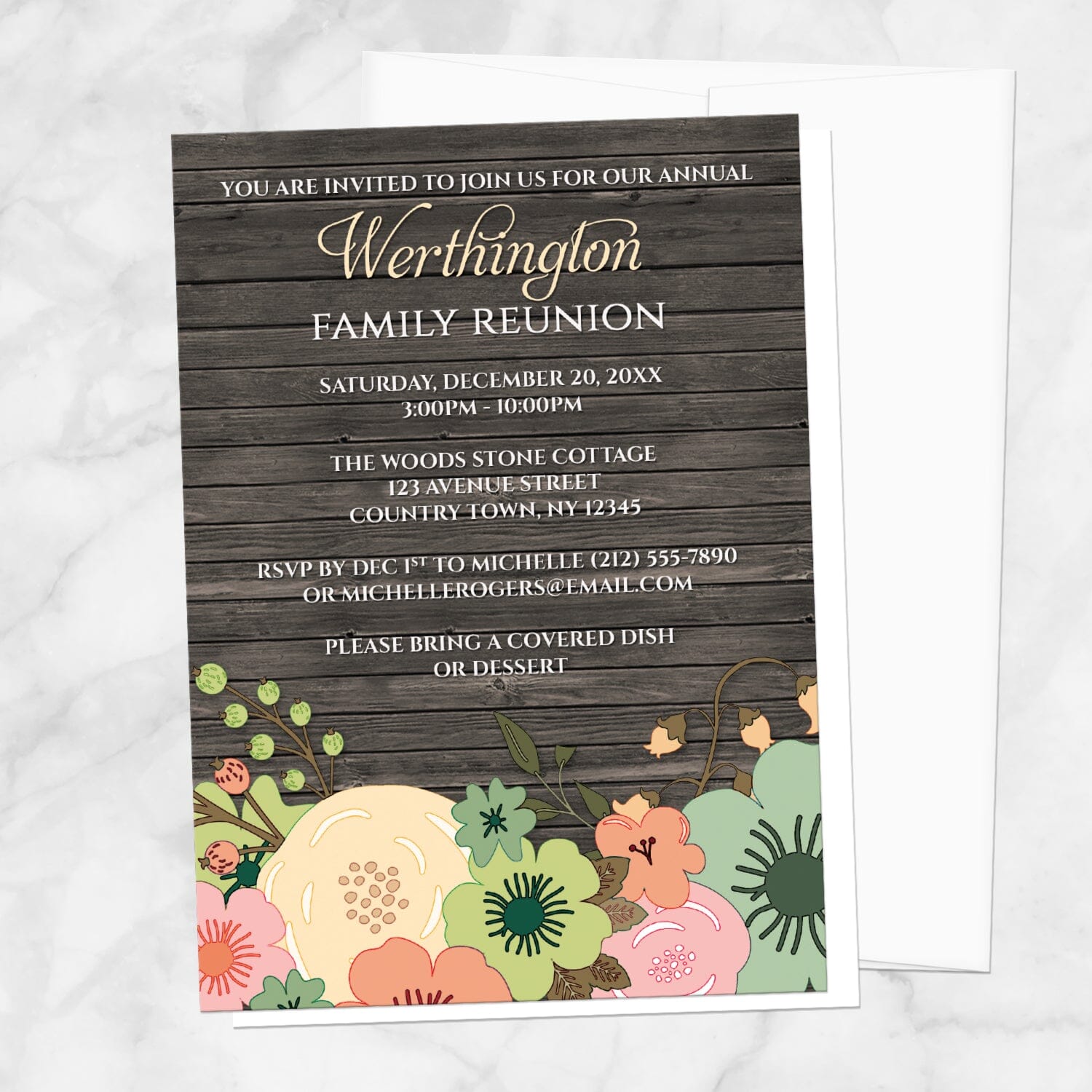 Rustic Orange Teal Floral Wood Family Reunion Invitation shown on a marble surface with a white envelope.