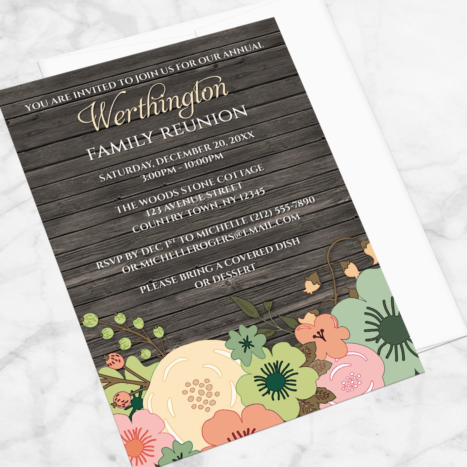 Rustic Orange Teal Floral Wood Family Reunion Invitation shown at an angle on a marble surface with a white envelope.