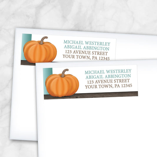 2 Rustic Orange Teal Pumpkin Address Labels shown on white envelopes on a marble surface