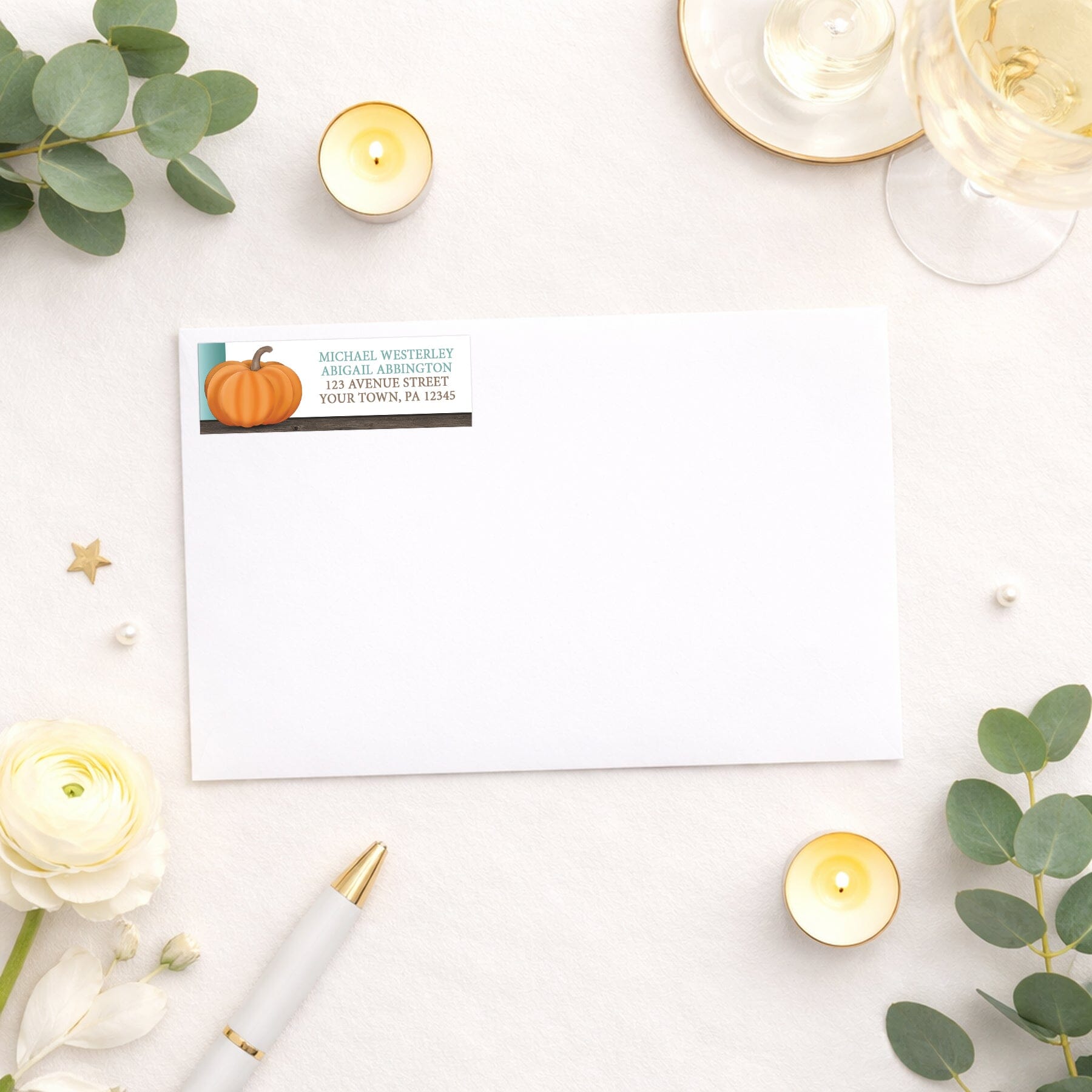 Rustic Orange Teal Pumpkin Address Label shown on a white envelope with wedding and shower supplies