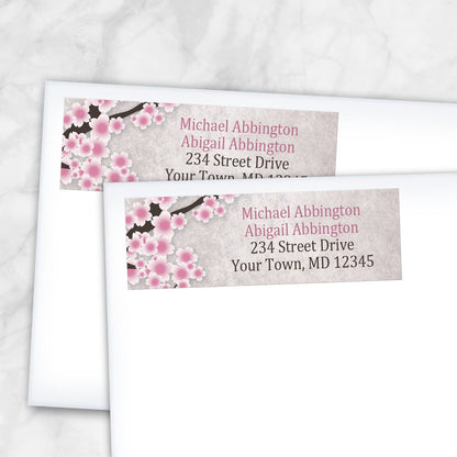 2 Rustic Pink Cherry Blossom Address Labels shown on white envelopes on a marble surface