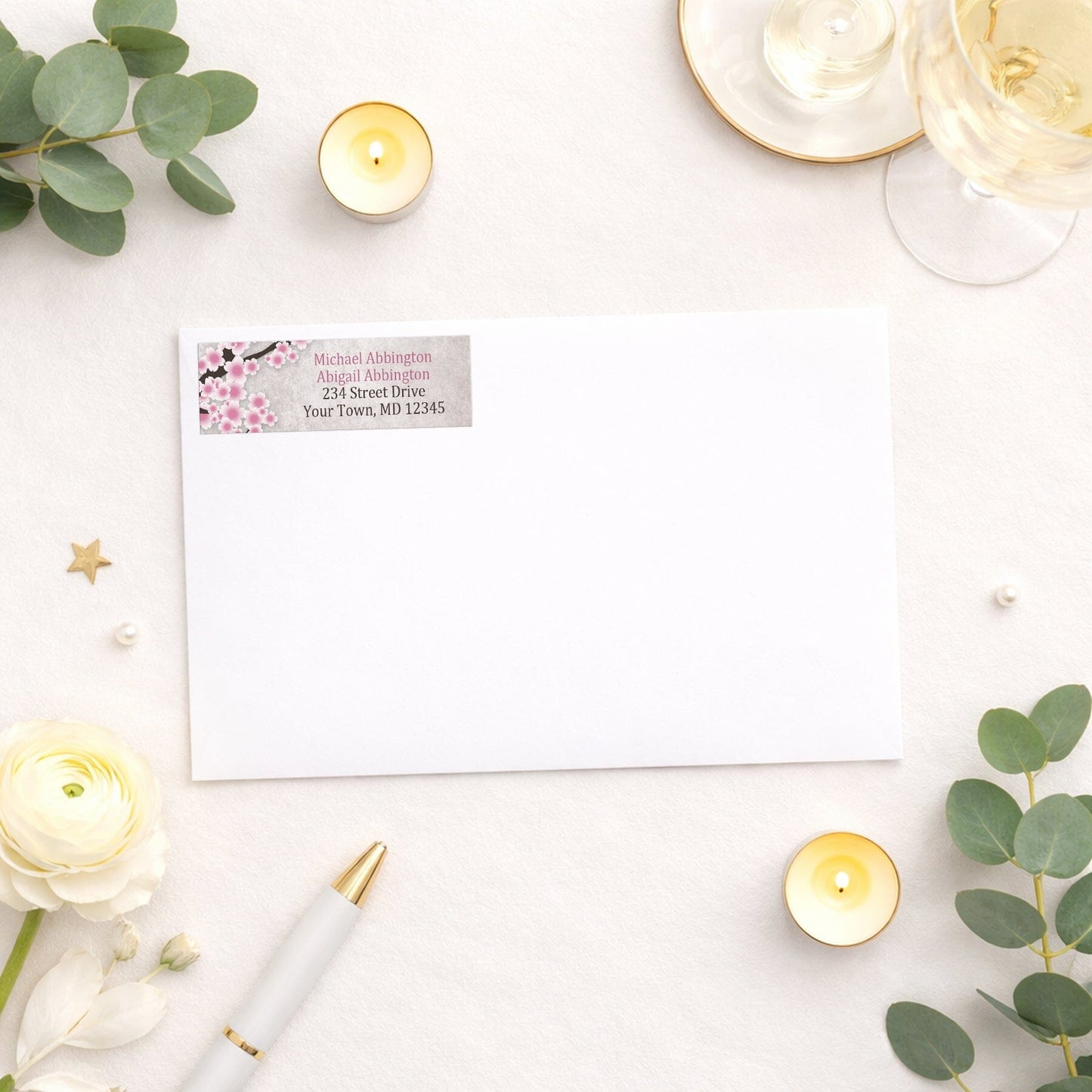 Rustic Pink Cherry Blossom Address Label shown on a white envelope with wedding and shower supplies