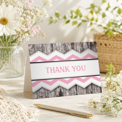 Rustic Pink Chevron and Wood Thank You Card shown on a tabletop with a vase, spring and summer flowers, and a pen.