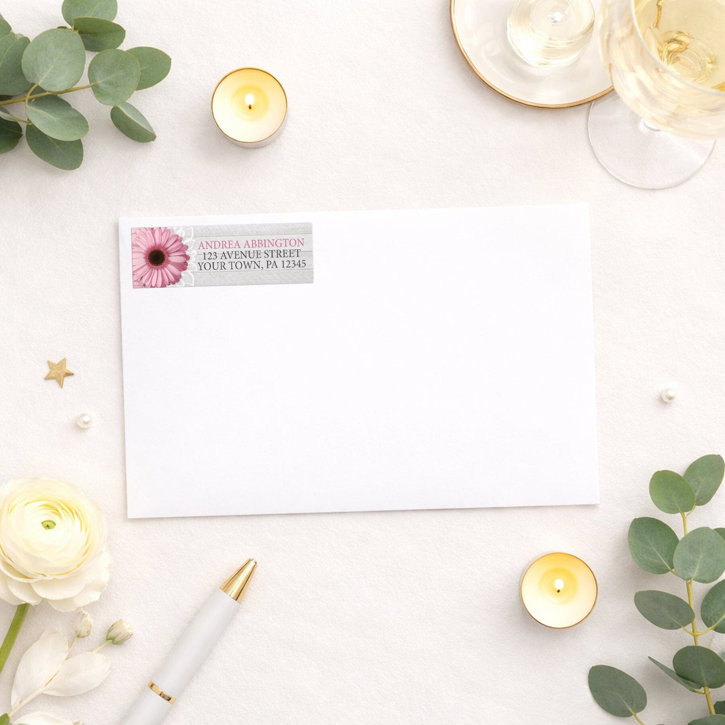 Rustic Pink Daisy Gray Wood Address Label shown on a white envelope with wedding and shower supplies