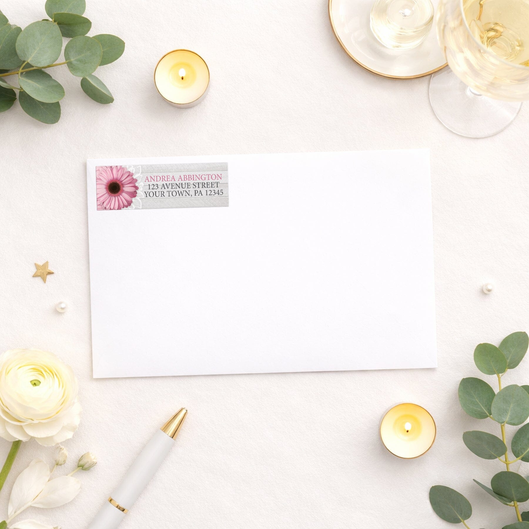 Rustic Pink Daisy Gray Wood Address Label shown on a white envelope with wedding and shower supplies