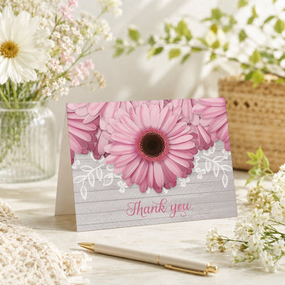 Rustic Pink Daisy Gray Wood Thank You Card on a tabletop with a vase, spring and summer flowers, and a pen.