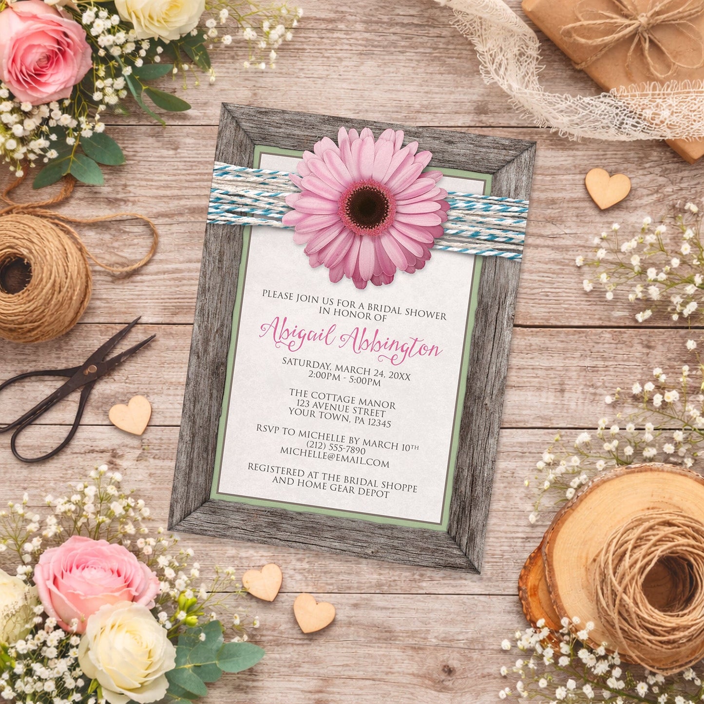 Rustic Pink Daisy Turquoise Wood Bridal Shower Invitation shown on a country-inspired wooden surface with spring and summer flowers, small wood hearts, and twine.