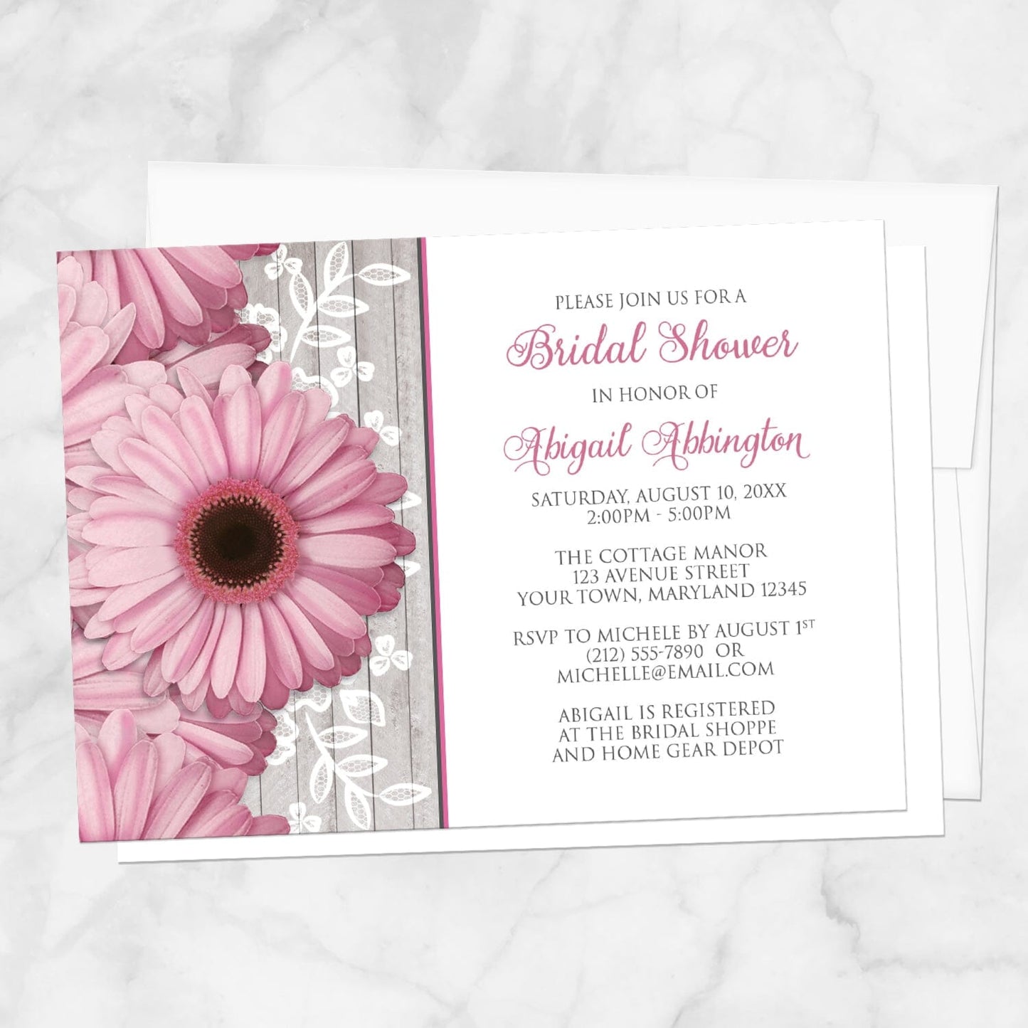 Rustic Pink Daisy Wood White Bridal Shower Invitation shown on a marble surface with a white envelope.