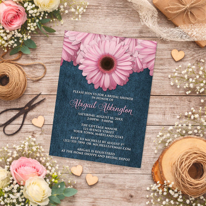 Rustic Pink Daisy and Denim Bridal Shower Invitation shown on a country wooden surface with spring and summer flowers, small wood hearts, and twine.