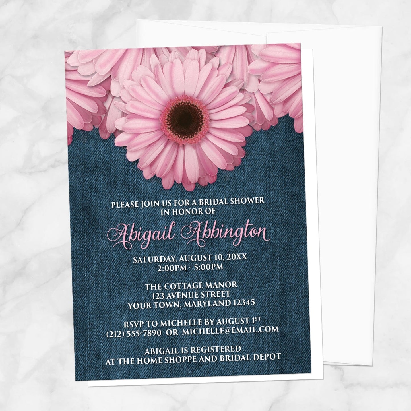 Rustic Pink Daisy and Denim Bridal Shower Invitation shown on a marble surface with a white envelope.