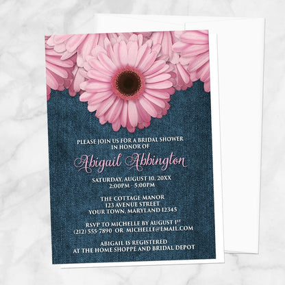 Rustic Pink Daisy and Denim Bridal Shower Invitation shown on a marble surface with a white envelope.
