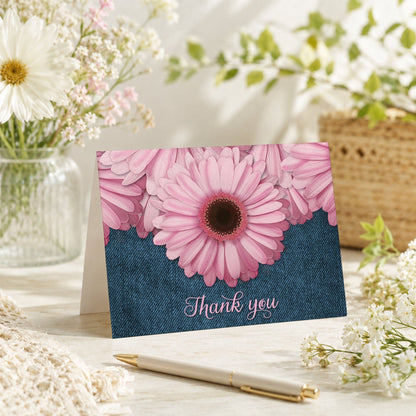 Rustic Pink Daisy and Denim Thank You Card shown on a tabletop with a vase, spring and summer flowers, and a pen.