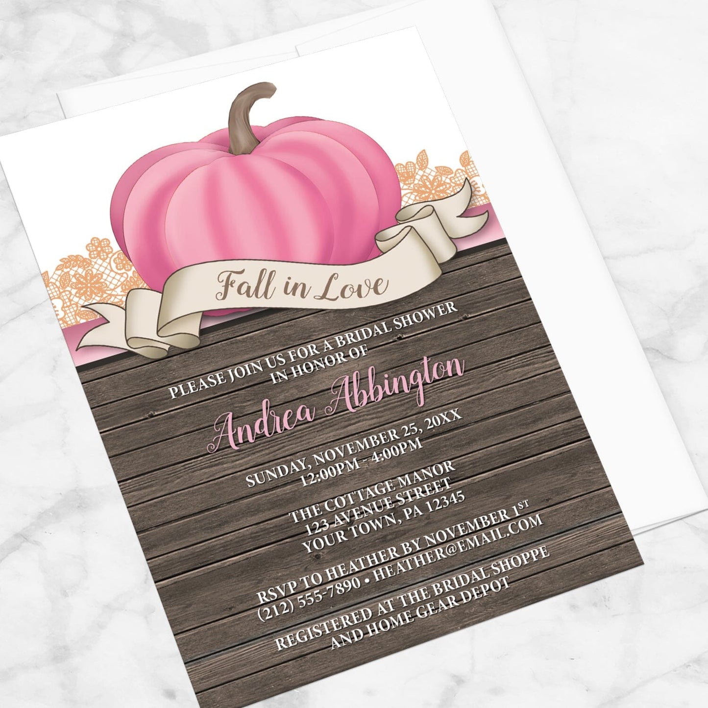 Rustic Pink Pumpkin Fall in Love Bridal Shower Invitation shown at an angle on a marble surface with a white envelope.