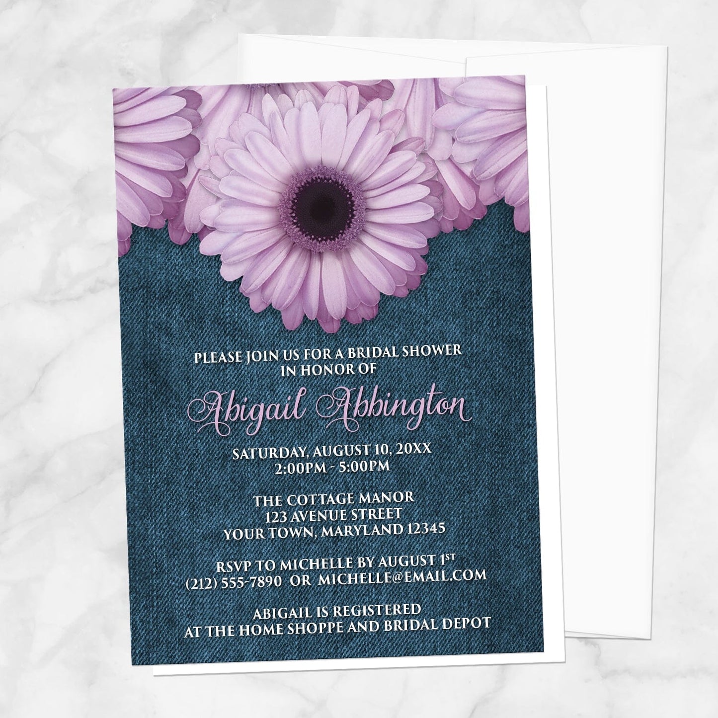 Rustic Purple Daisy Denim Bridal Shower Invitation shown on a marble surface with a white envelope.