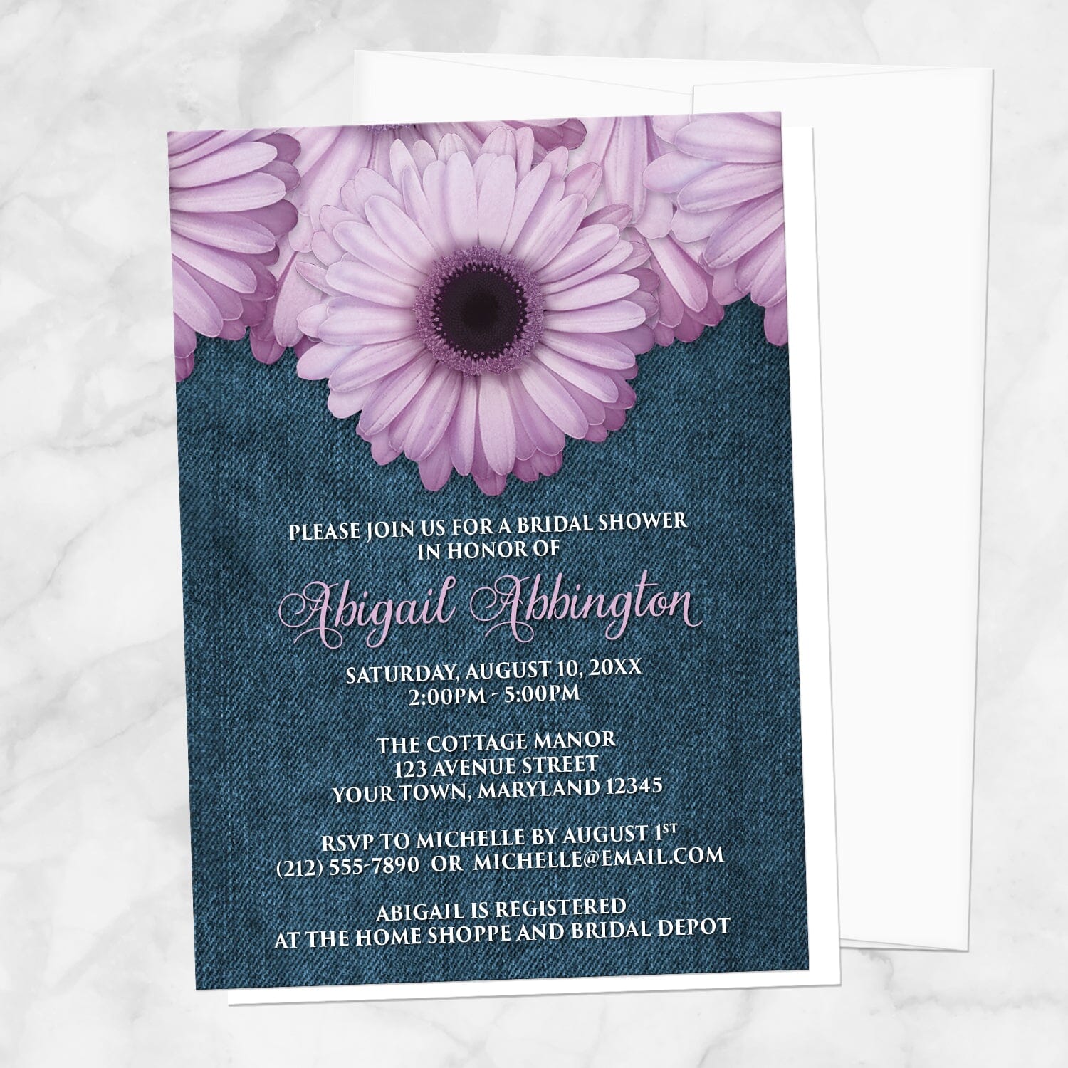 Rustic Purple Daisy Denim Bridal Shower Invitation shown on a marble surface with a white envelope.